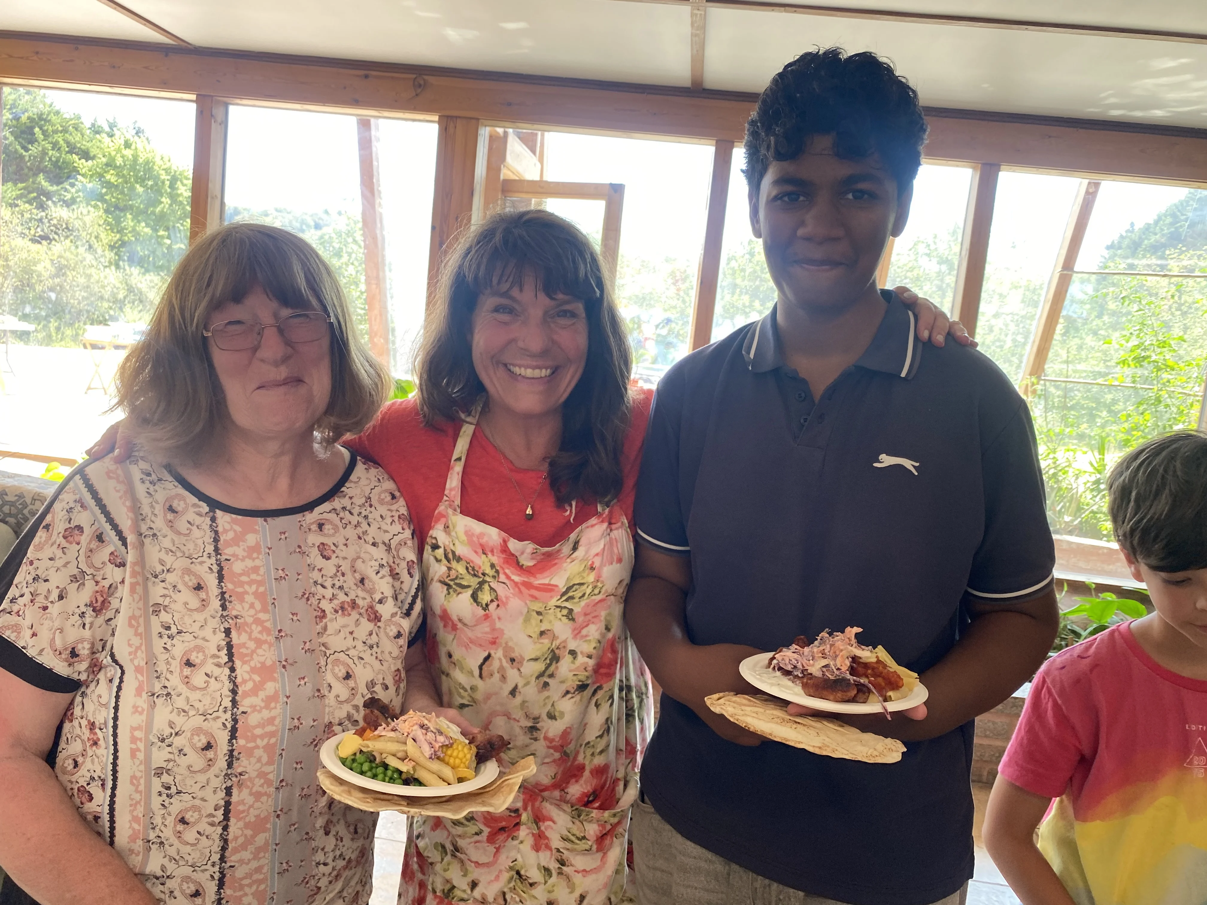 Family group holding plates of food